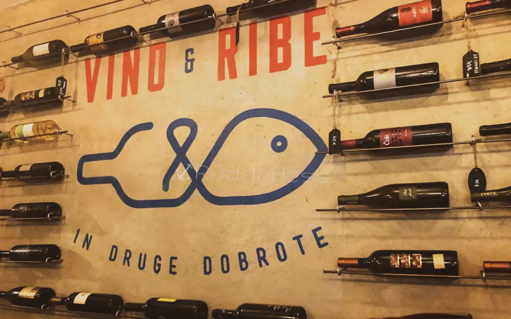 wall display with several bottles of wine at Vino & Ribe in Ljubljana