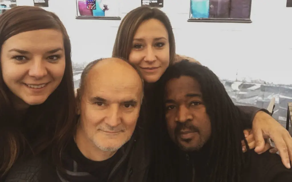two men and two women posing for a picture