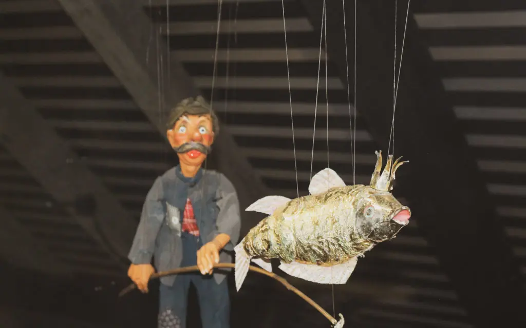 fisherman puppy and a fish puppet