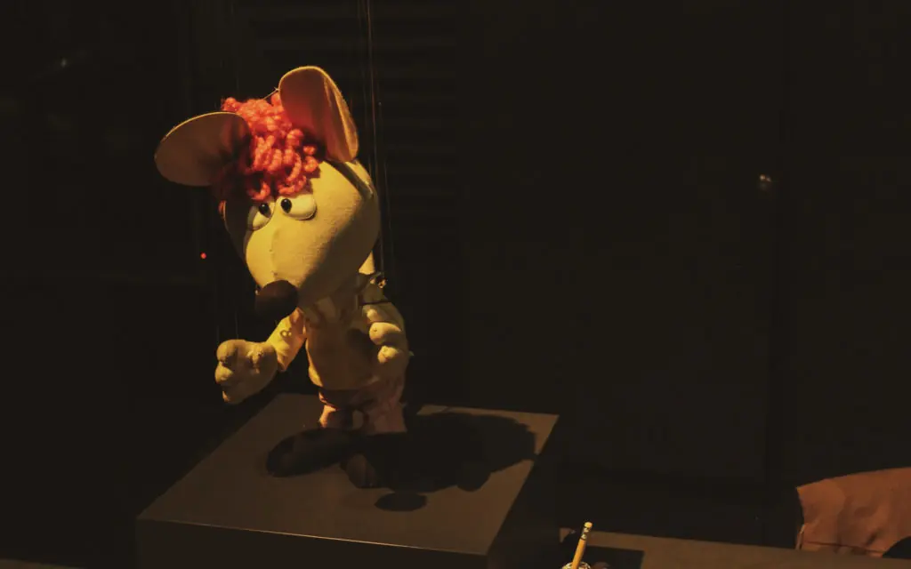 mouse puppet standing on a table