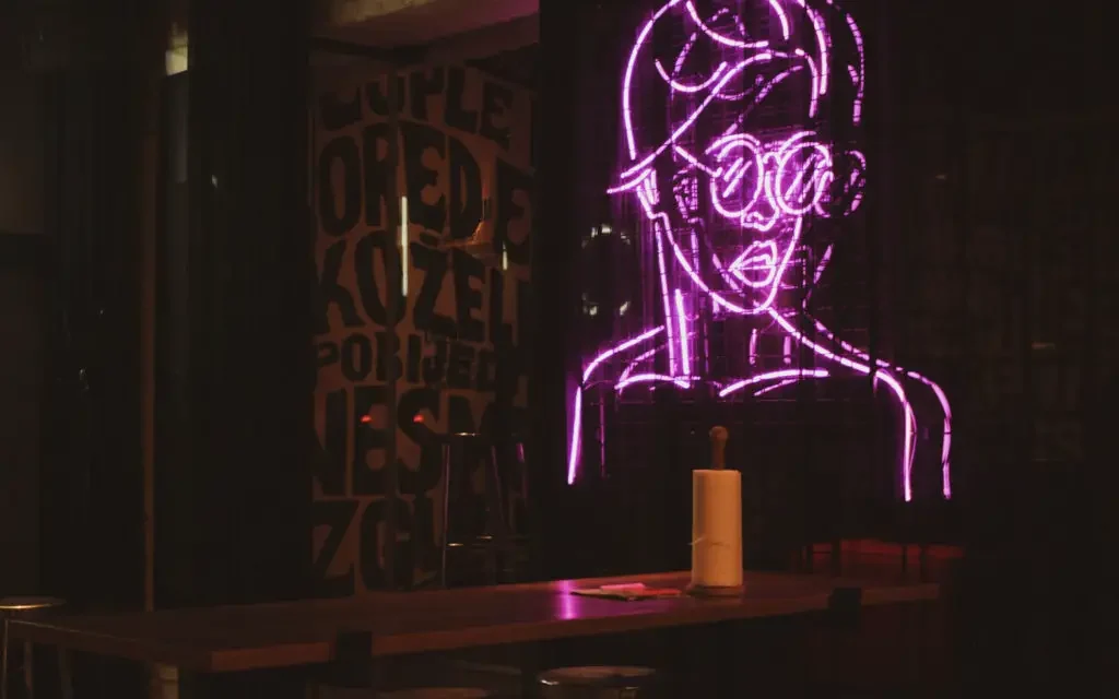 a neon sign of a person on a wall