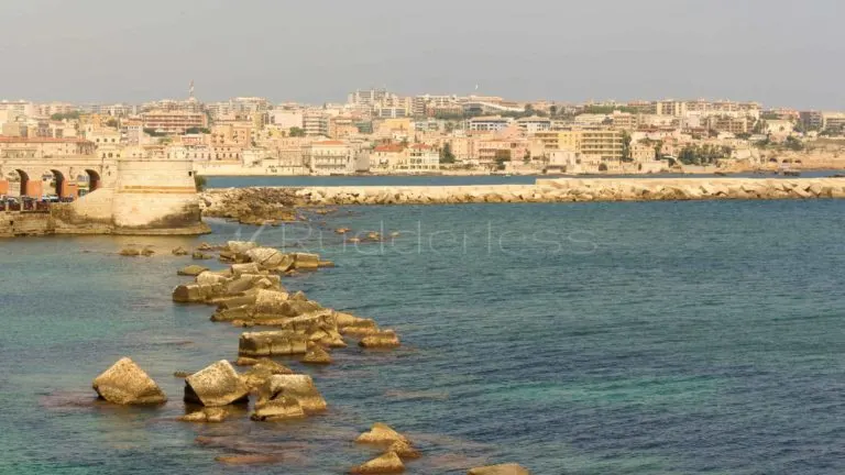a photo of Syracuse, Sicily from across the water