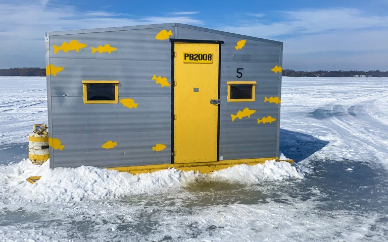 ice fishing hunt with a yellow door on a frozen lake