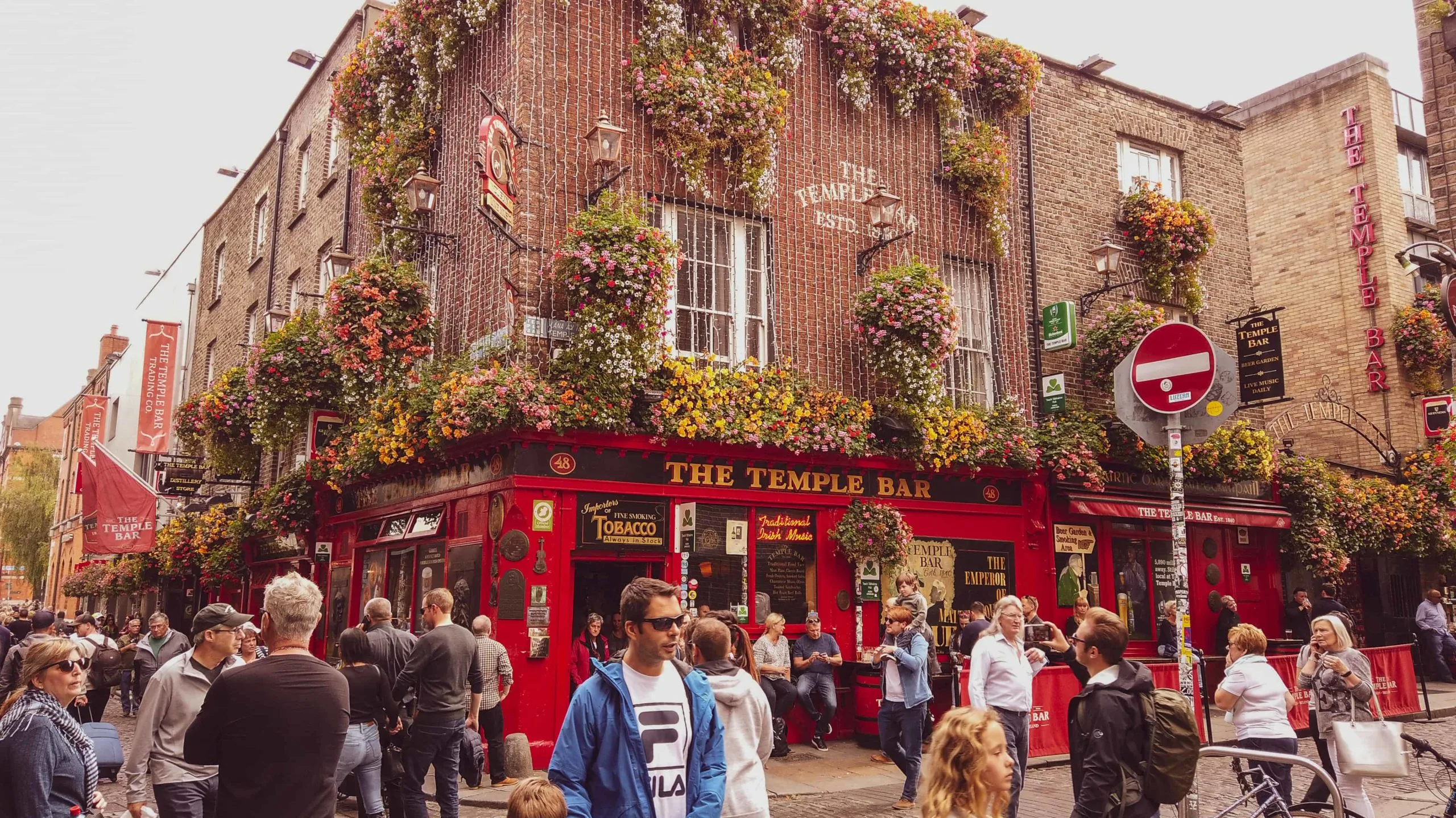 large groups of people walking outside The Temple Bar in Dublin