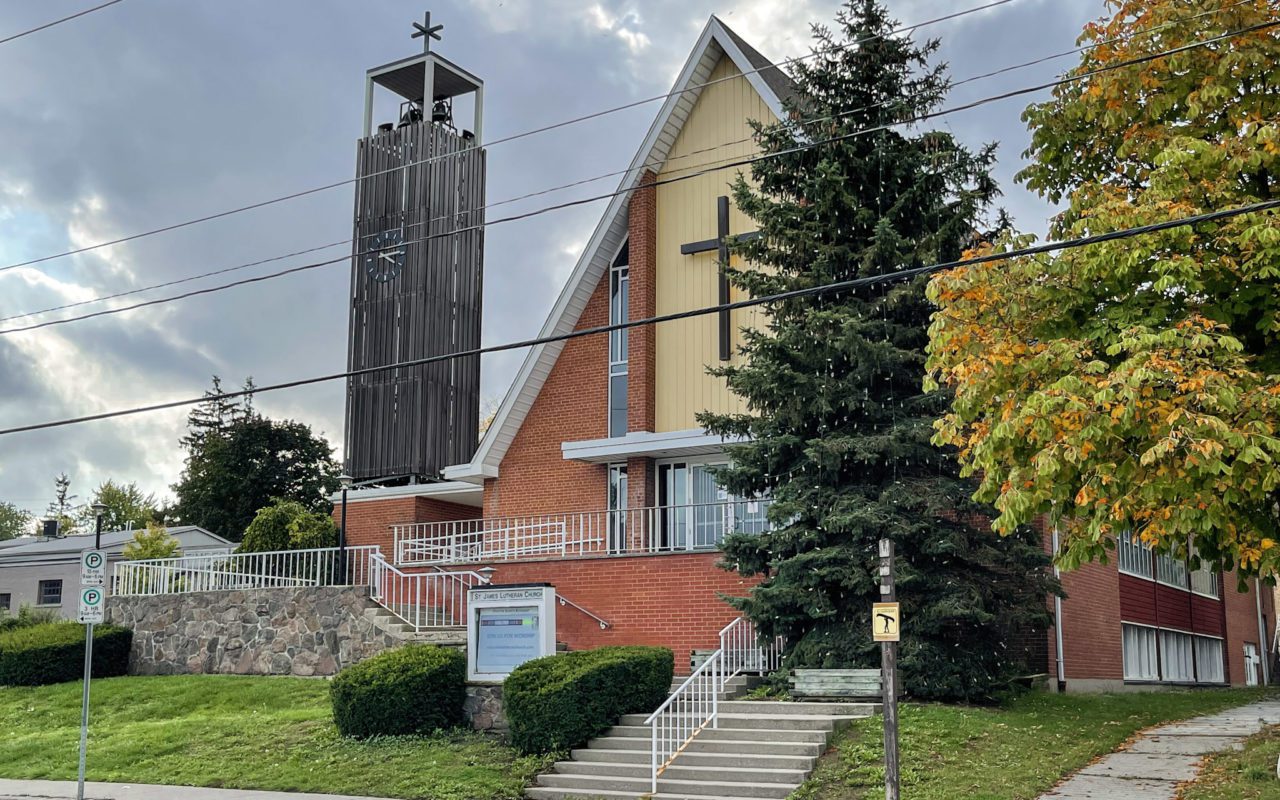 Red brick church with a large cross displayed on the front above the front doors | st jacobs country tourism